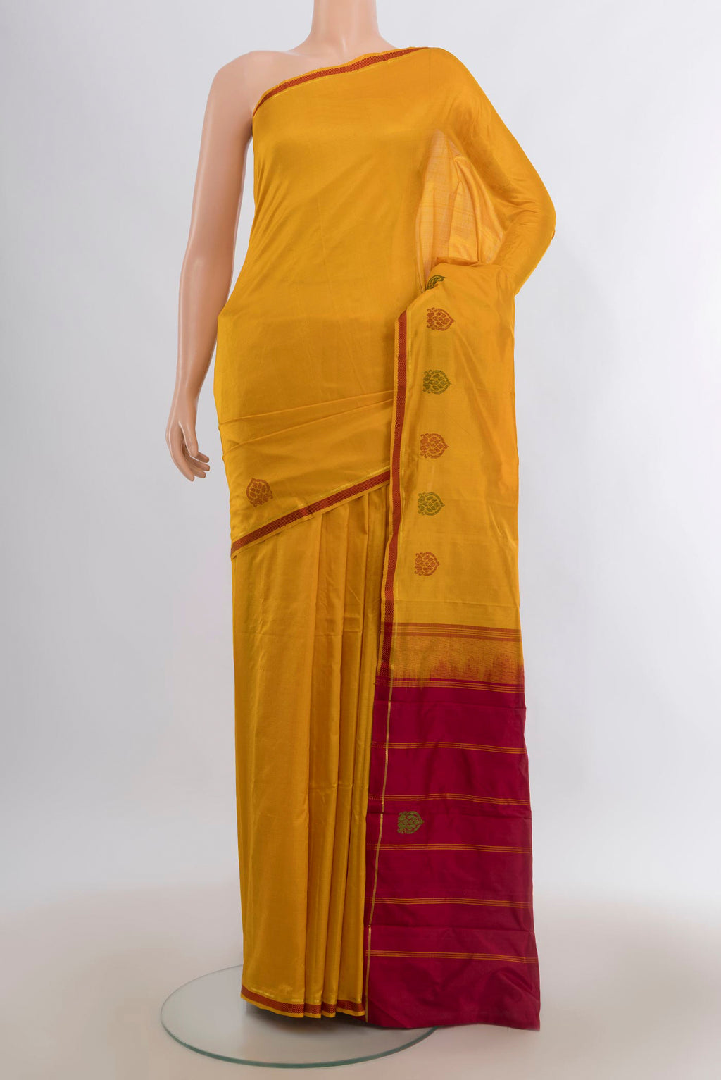 Pure Silk Mustard Kanjivaram Saree with Plain Body and Thread Border.  displayed on a mannequin