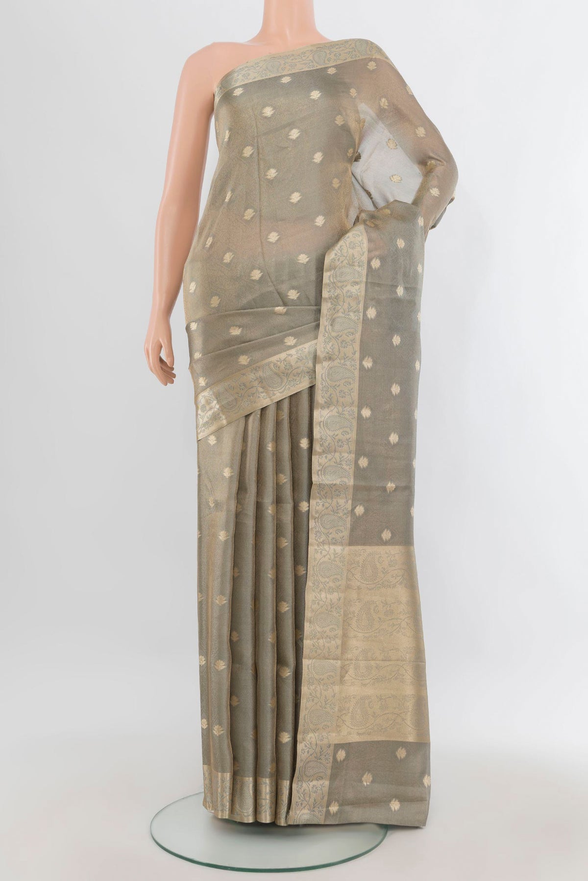 Grey Tissue Saree with Zari Butta on the body and Zari Border.  displayed on a mannequin