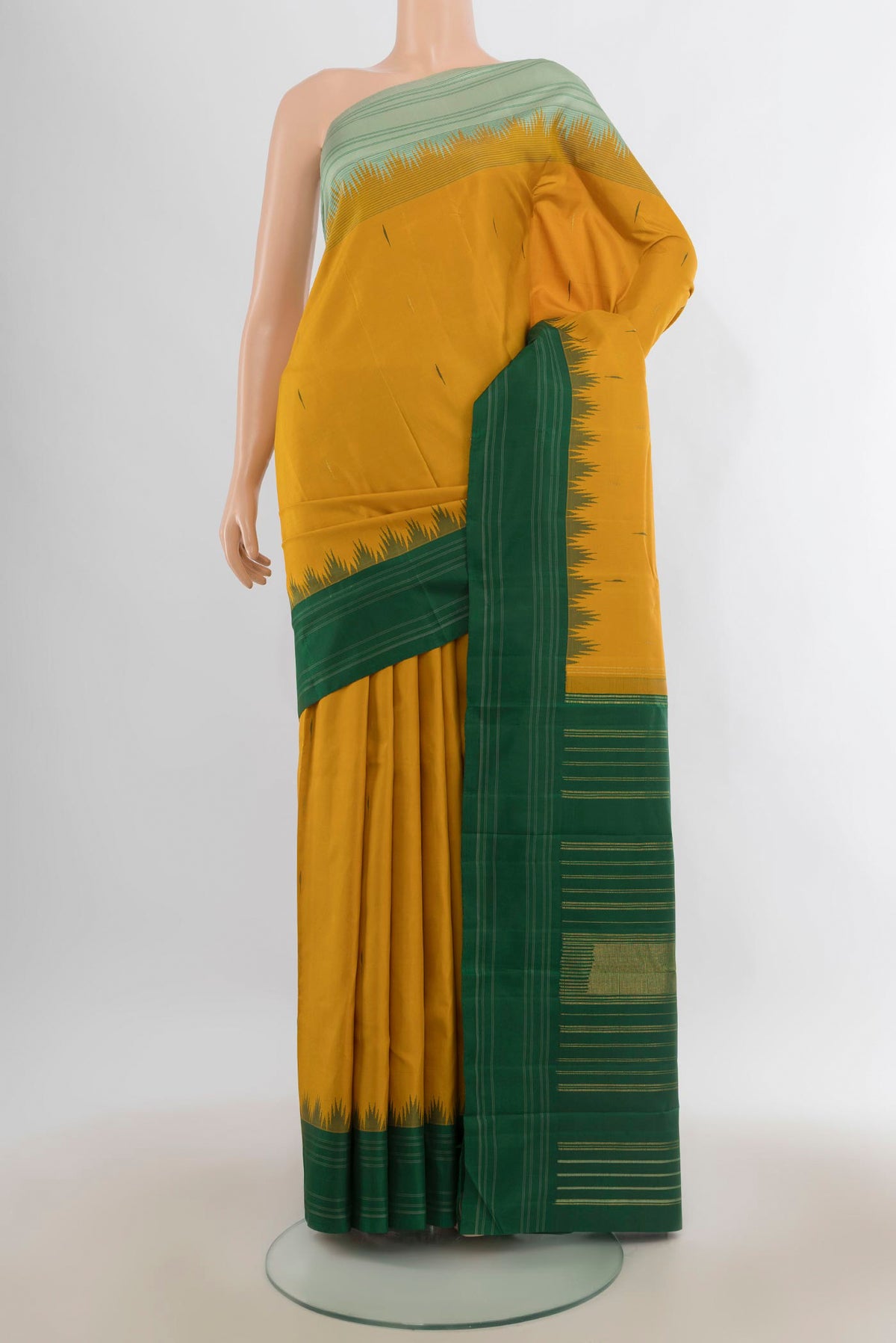 Pure Silk Mustard Kanchipuram Saree with Plain Body and Ganga Jamuna Border.  displayed on a mannequin