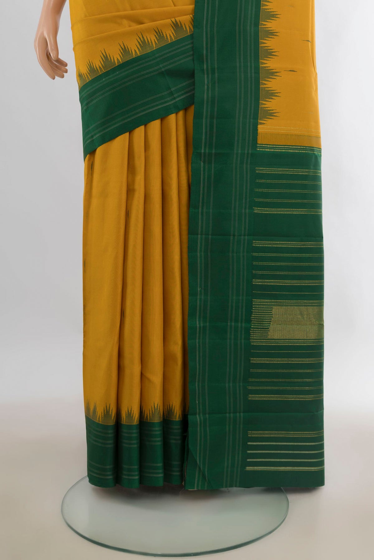 Pleats and pallu of Pure Silk Mustard Kanchipuram Saree with Plain Body and Ganga Jamuna Border. 