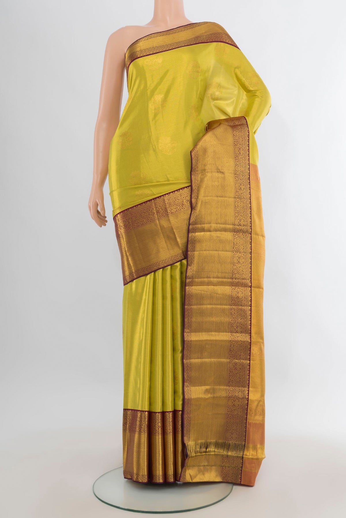 Golden Dual Tone Kanchipuram Tissue Saree with Zari Butta on the body and Zari Border.  displayed on a mannequin