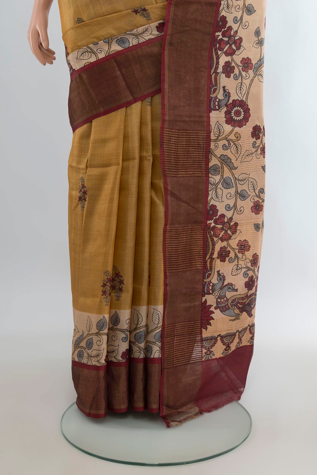 Pleats and pallu of Mustard Tussar Saree with Floral Print on the body and Zari Border. 