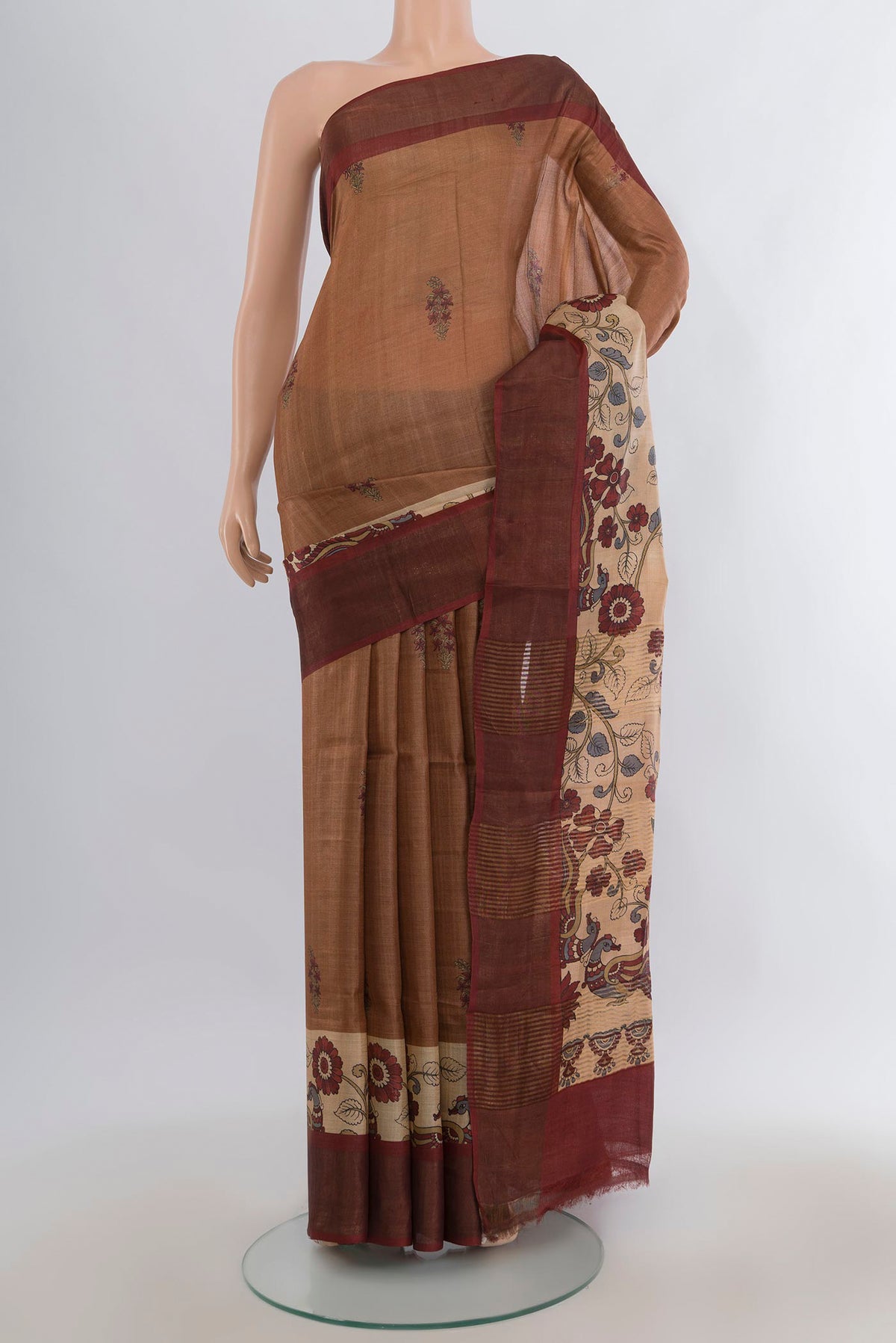 Brown Tussar Saree with Floral Print on the body and Zari Border.  displayed on a mannequin