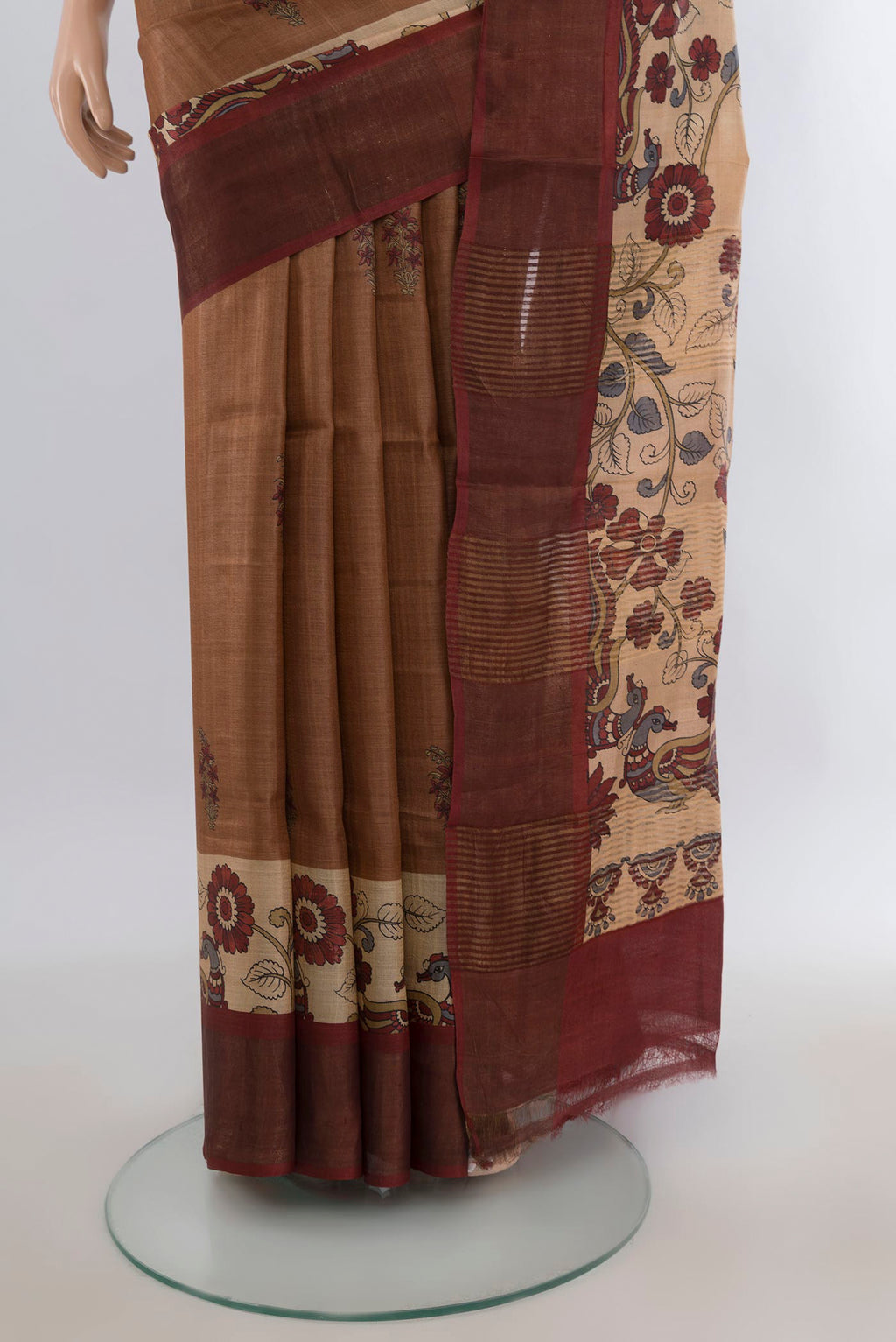 Pleats and pallu of Brown Tussar Saree with Floral Print on the body and Zari Border. 