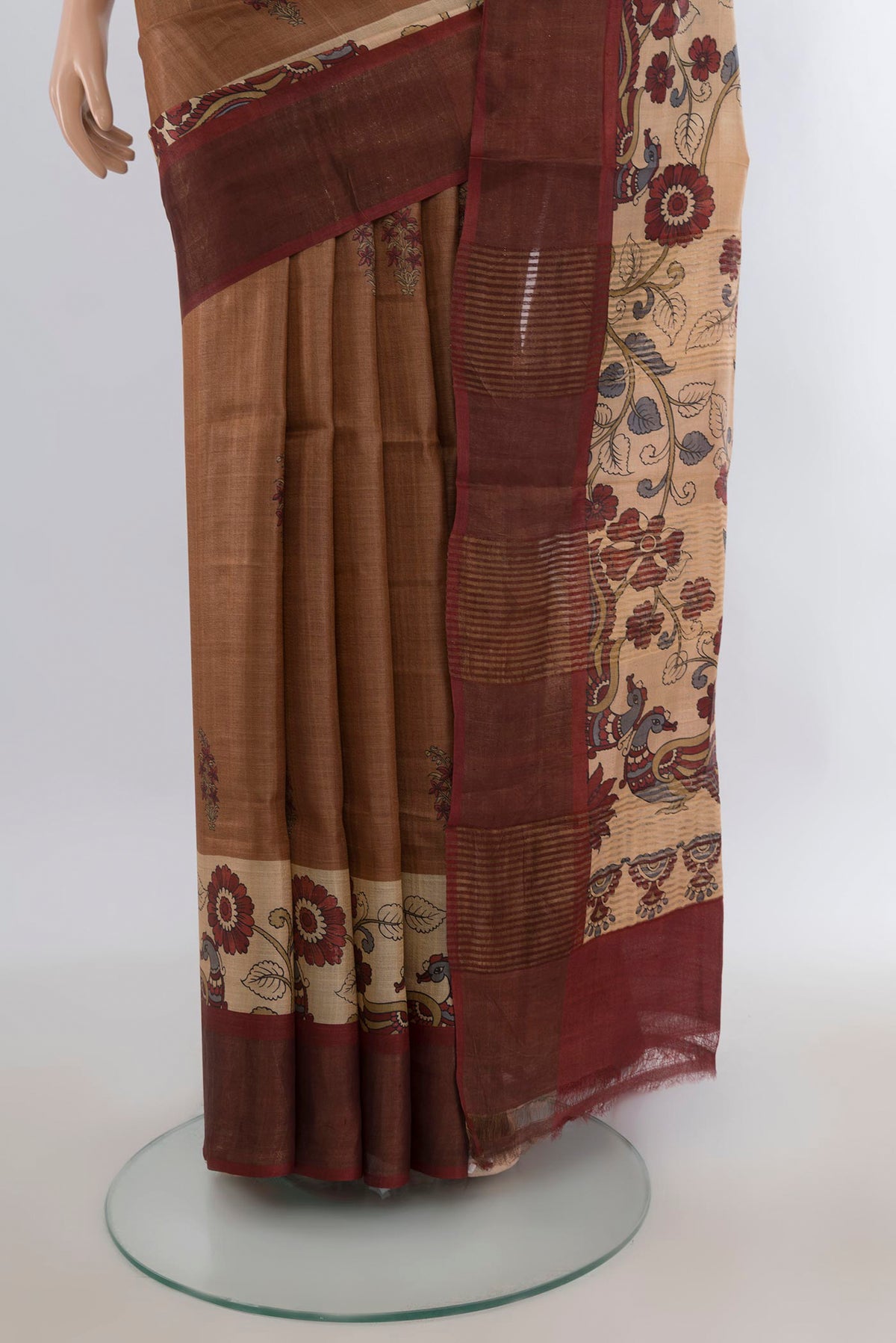 Pleats and pallu of Brown Tussar Saree with Floral Print on the body and Zari Border. 