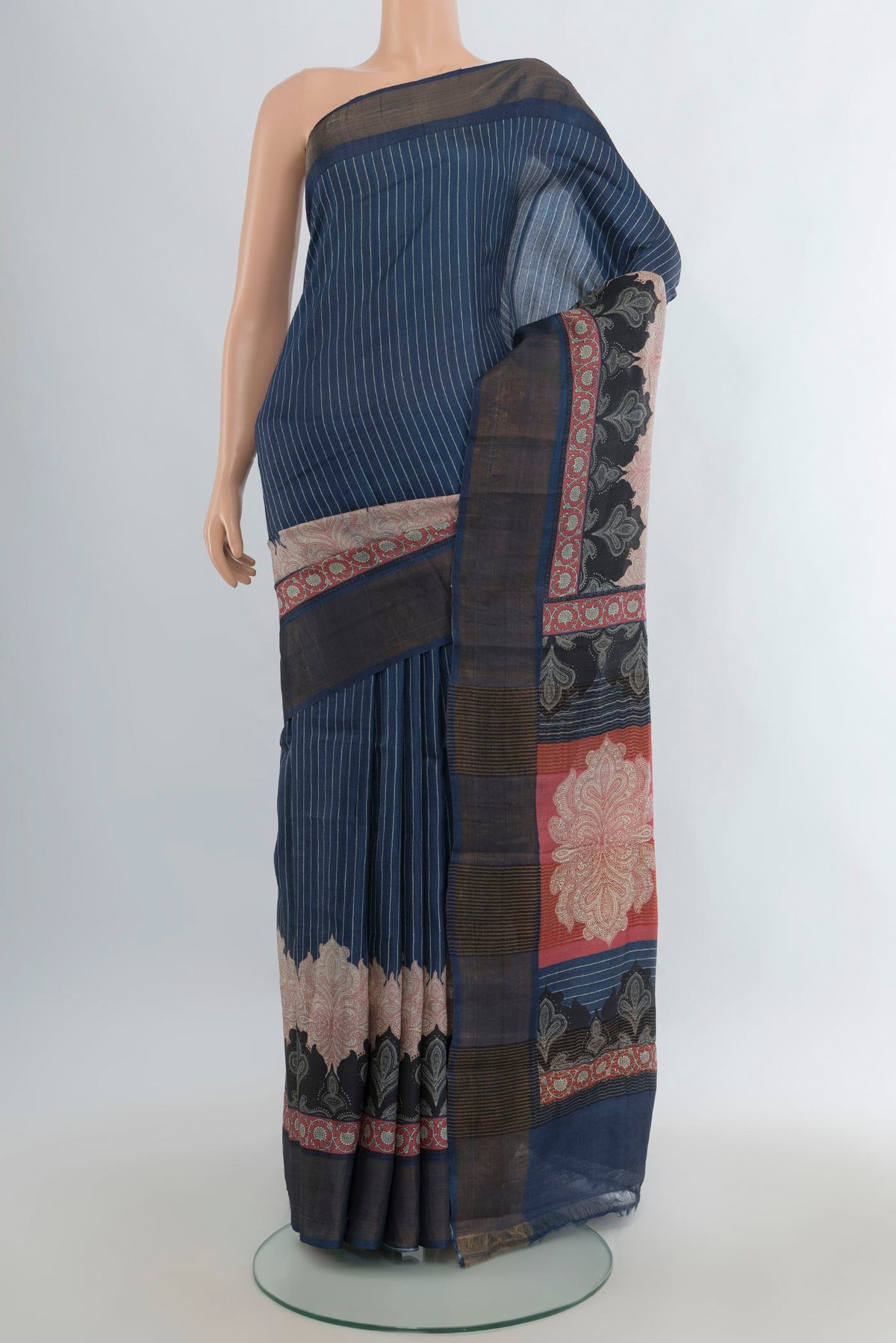 Navy Blue Tussar Saree with Printed design on the body and Zari Border.  displayed on a mannequin