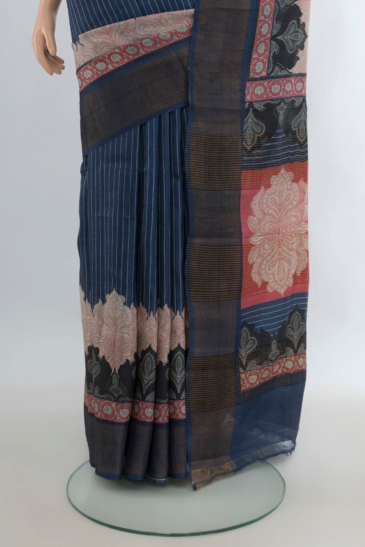Pleats and pallu of Navy Blue Tussar Saree with Printed design on the body and Zari Border. 