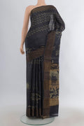 Black Tussar Saree with Printed design on the body and Zari Border.  displayed on a mannequin