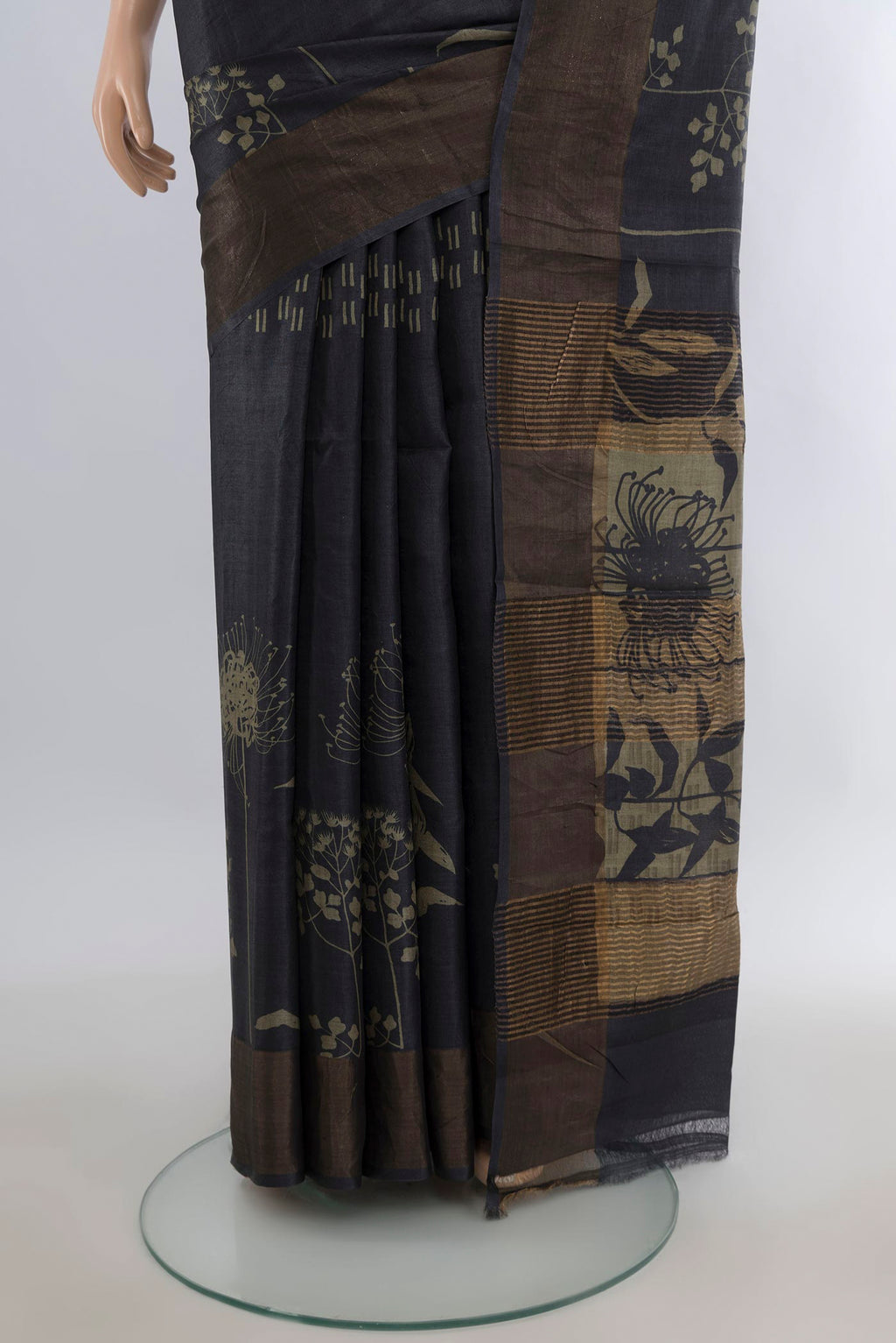 Pleats and pallu of Black Tussar Saree with Printed design on the body and Zari Border. 