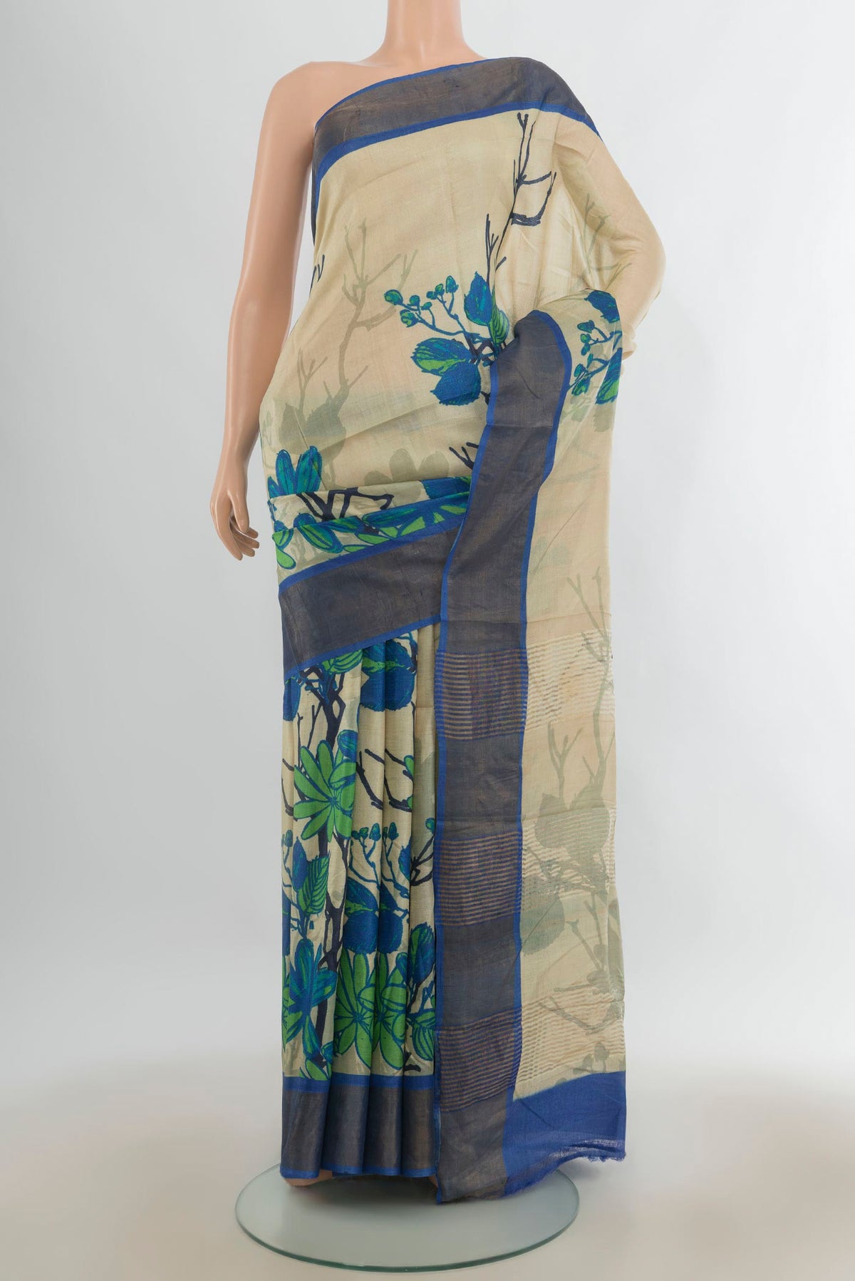 Cream Tussar Saree with Floral Print on the body and Zari Border.  displayed on a mannequin