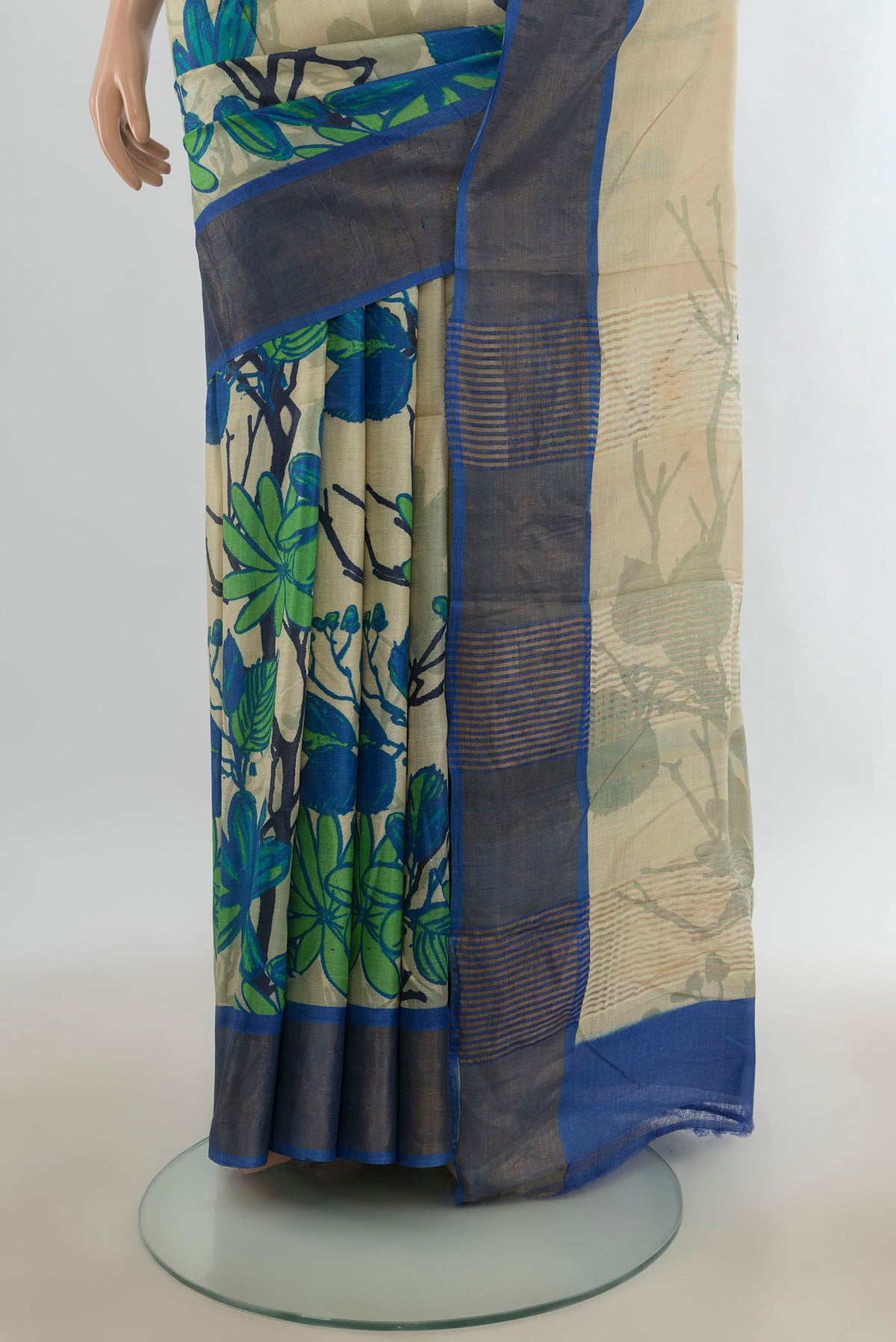 Pleats and pallu of Cream Tussar Saree with Floral Print on the body and Zari Border. 