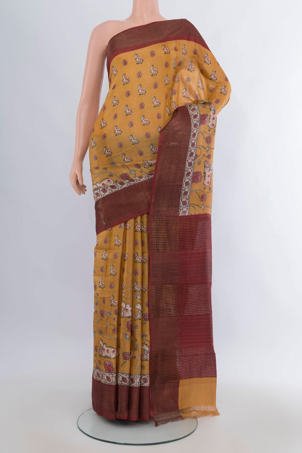 Yellow Tussar Saree with Floral Print on the body and Zari Border.  displayed on a mannequin