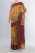 Yellow Tussar Saree with Floral Print on the body and Zari Border.  displayed on a mannequin