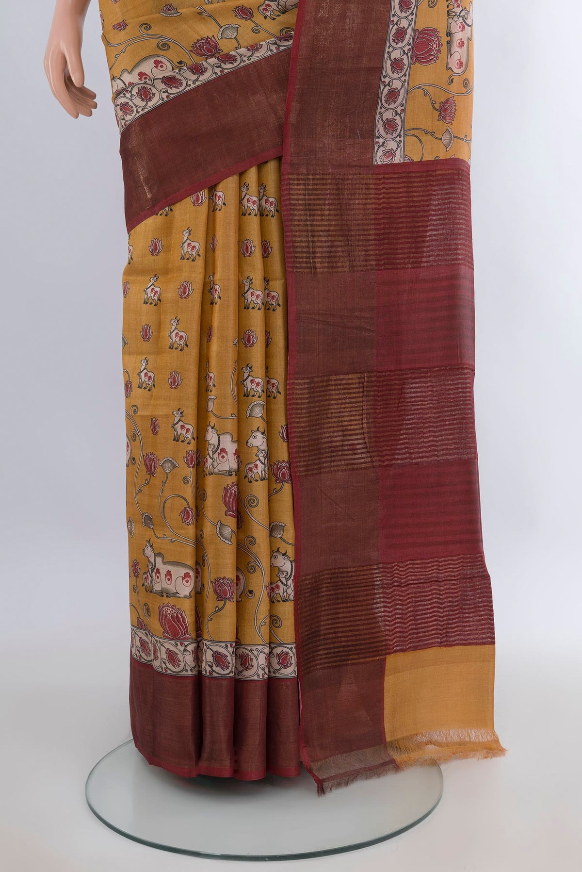 Pleats and pallu of Yellow Tussar Saree with Floral Print on the body and Zari Border. 