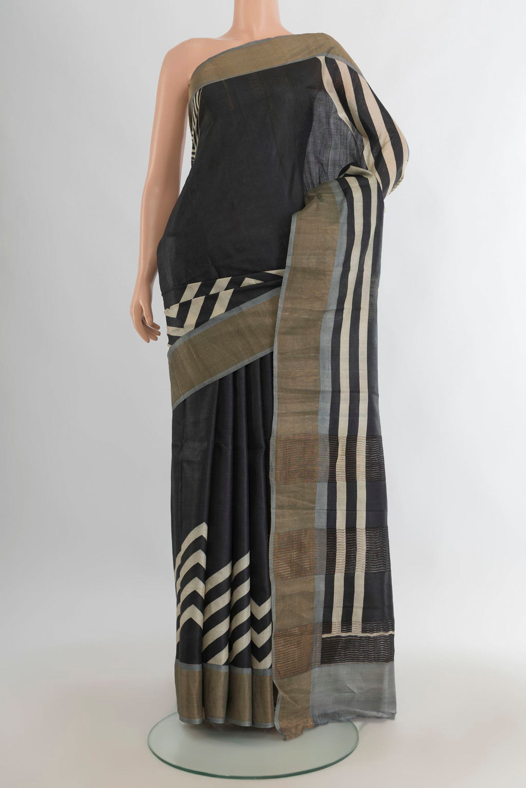 Black Tussar Saree with Floral Print on the body and Zari Border.  displayed on a mannequin