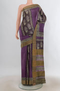 Purple Tussar Saree with Printed design on the body and Zari Border.  displayed on a mannequin