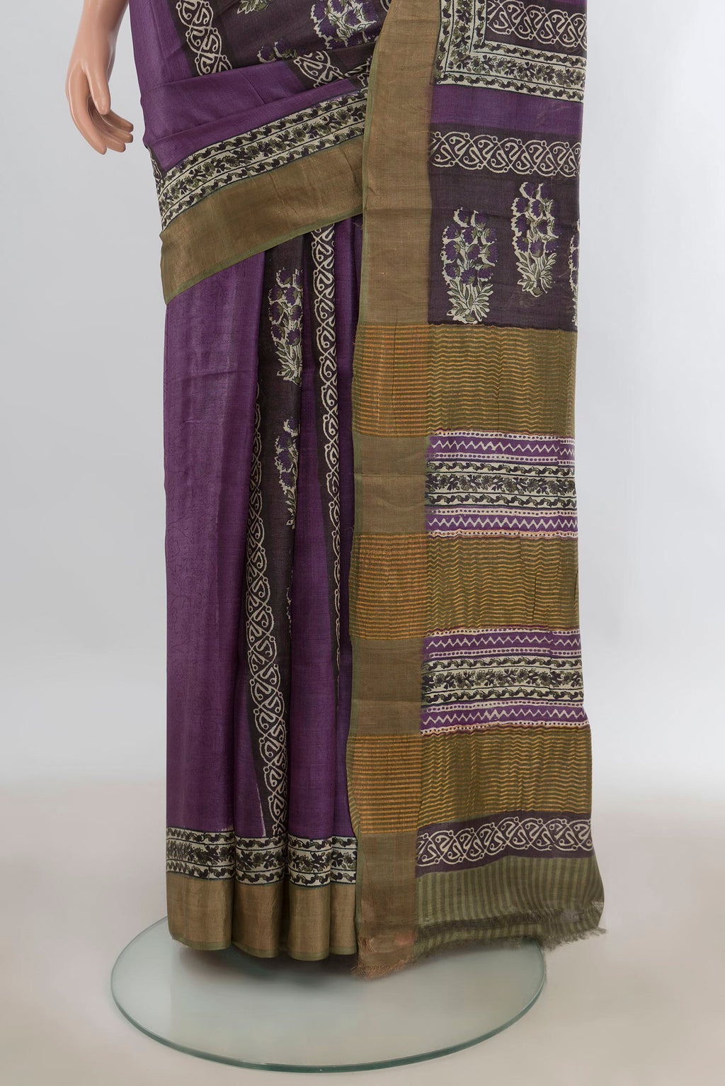 Pleats and pallu of Purple Tussar Saree with Printed design on the body and Zari Border. 