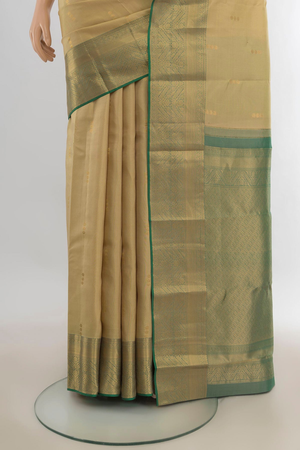 Pleats and pallu of Pure Silk Beige Kanjivaram Saree with Zari Butta on the body and Zari Border. 
