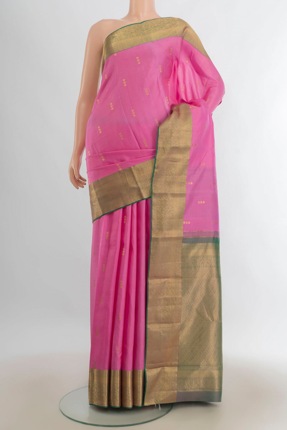 Pure Silk Rose pink Kanjivaram Saree with Zari Butta on the body and Silk Border.  displayed on a mannequin