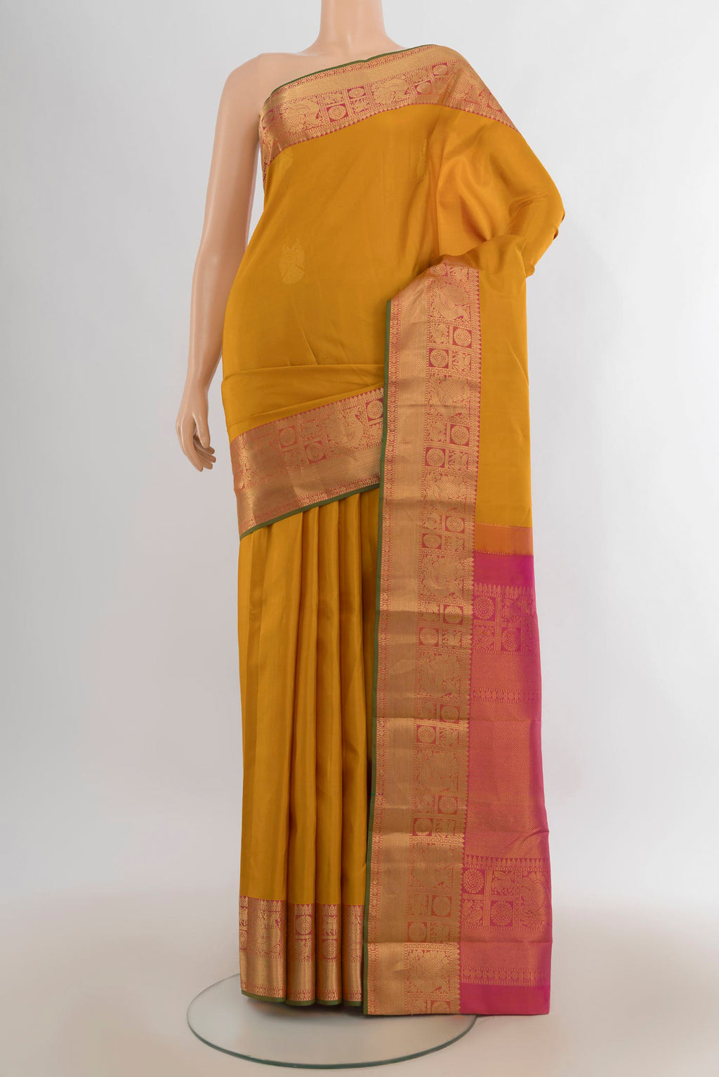 Pure Silk Mustard Kanjivaram Saree with Zari Butta on the body and Zari Border.  displayed on a mannequin
