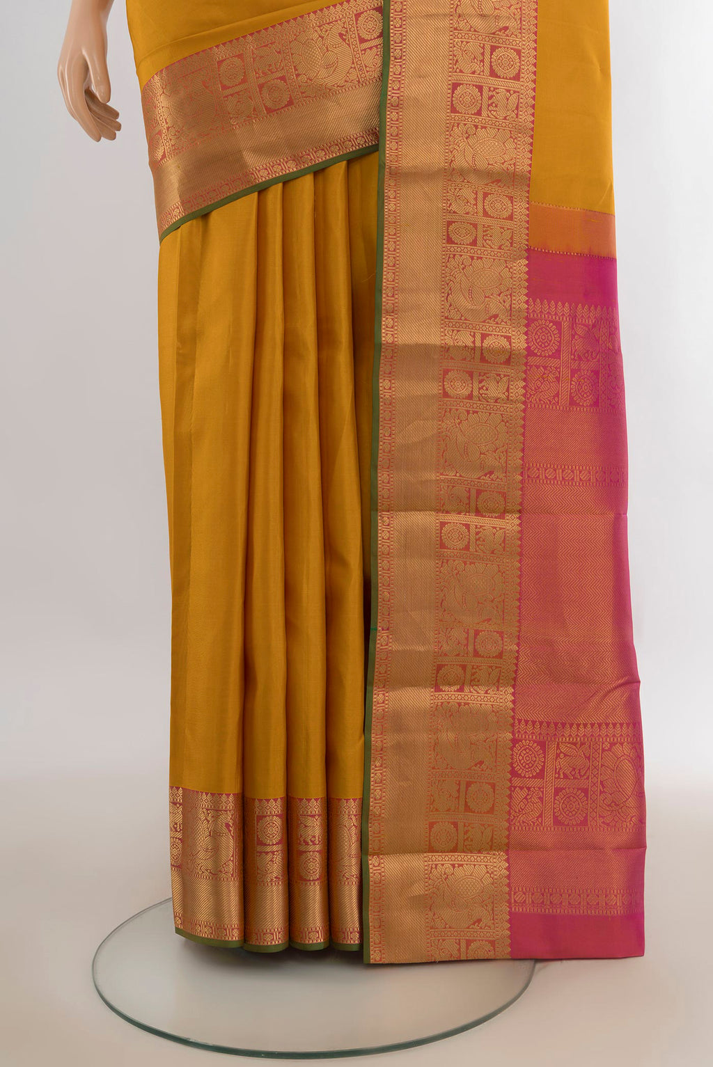 Pleats and pallu of Pure Silk Mustard Kanjivaram Saree with Zari Butta on the body and Zari Border. 