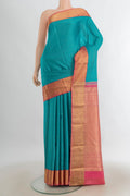 Pure Silk Light Blue Kanjivaram Saree with Zari Butta on the body and Silk Border.  displayed on a mannequin