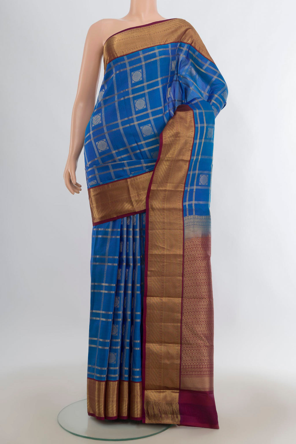 Pure Silk Blue Kanchipuram Saree with Checked design on the body and Zari Border.  displayed on a mannequin