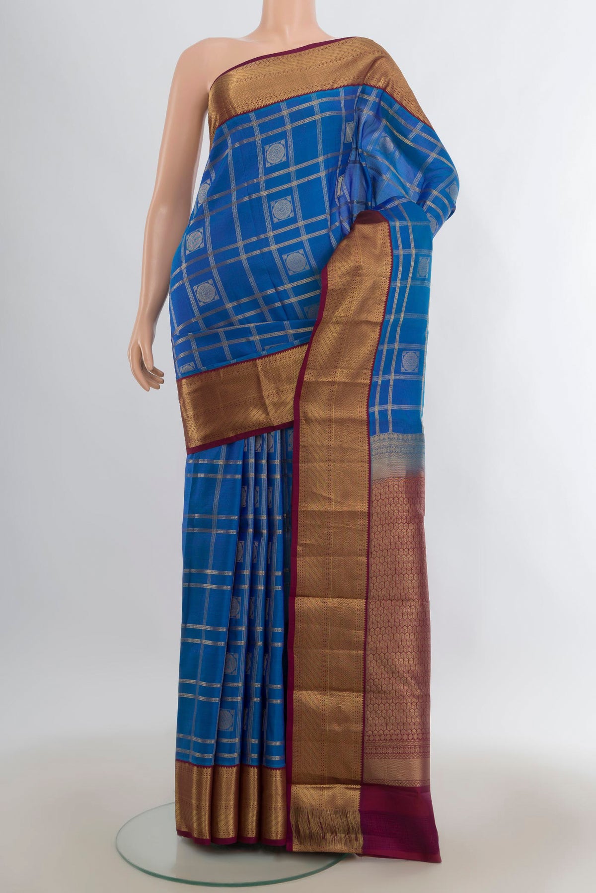 Pure Silk Blue Kanchipuram Saree with Checked design on the body and Zari Border.  displayed on a mannequin
