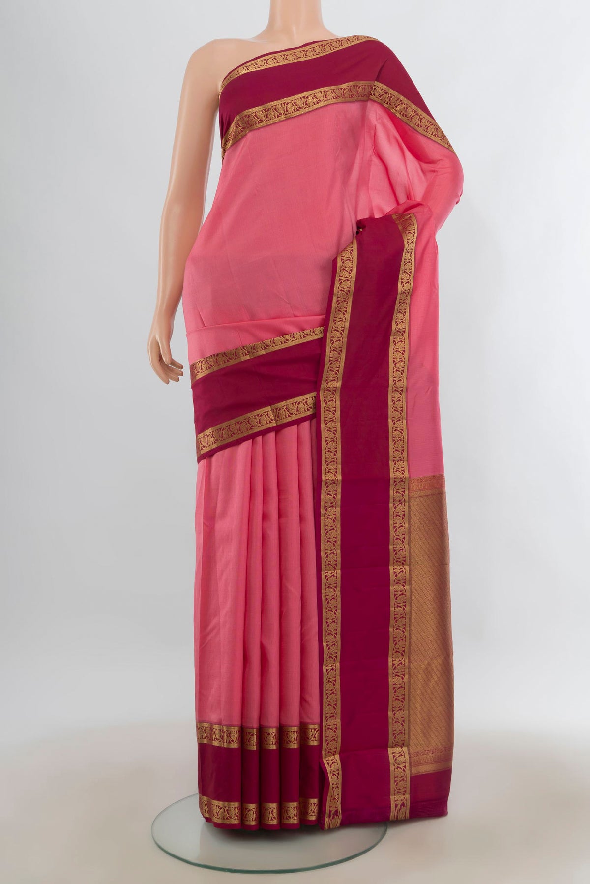 Pure Silk Pink Kanchipuram Saree with Checked design on the body and Zari Border.  displayed on a mannequin
