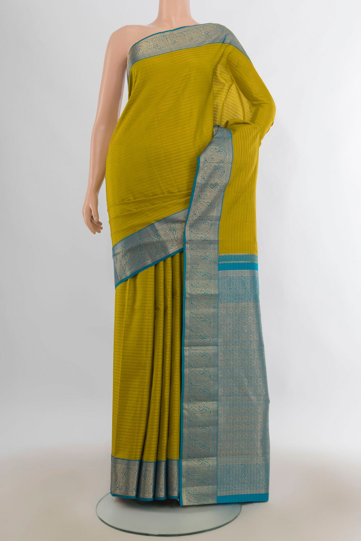 Pure Silk Mehandi Green Kanjivaram Saree with Stripes on the body and Zari Border.  displayed on a mannequin