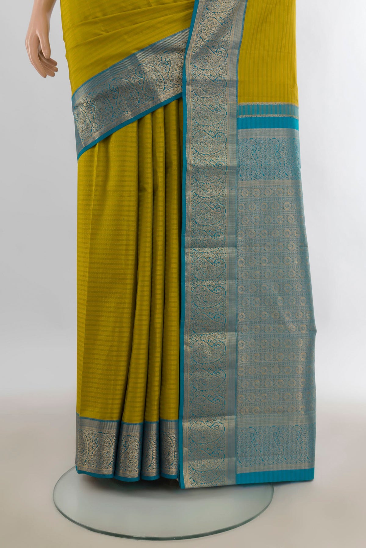 Pleats and pallu of Pure Silk Mehandi Green Kanjivaram Saree with Stripes on the body and Zari Border. 