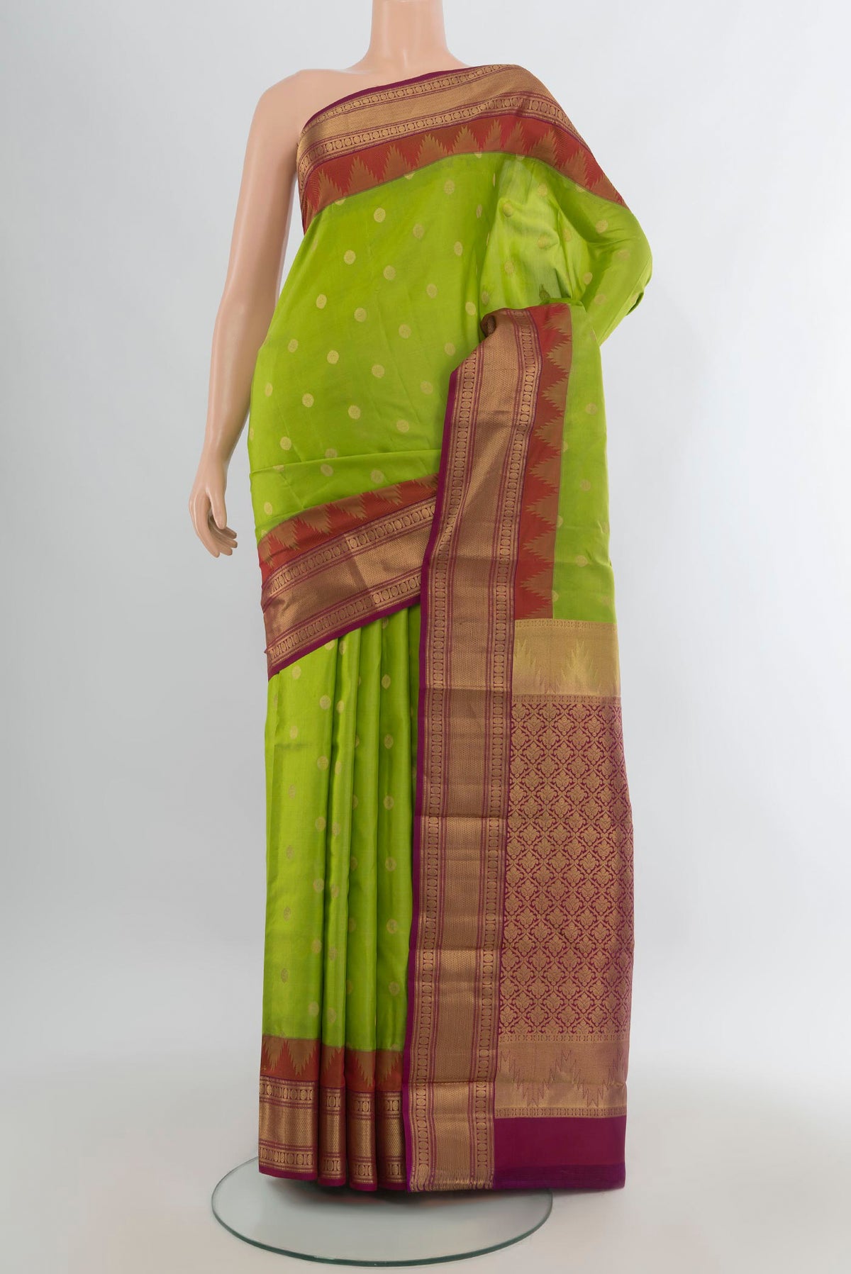 Pure Silk Parrot Green Kanjivaram Saree with Zari Butta on the body and Zari Border.  displayed on a mannequin