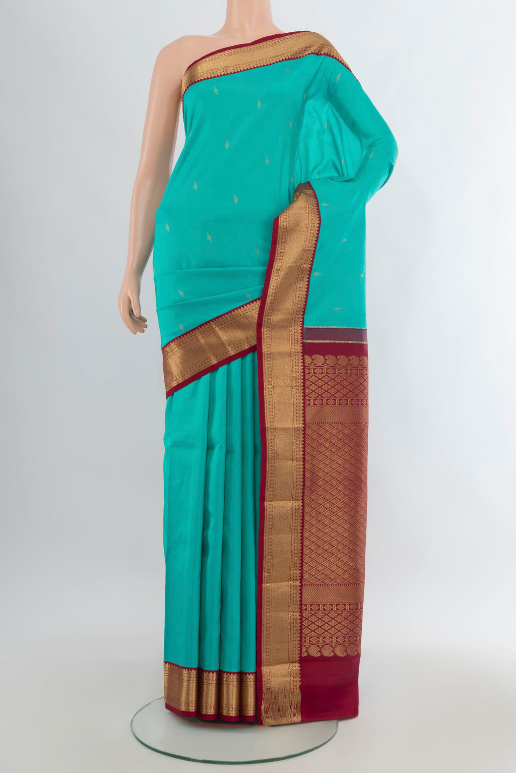 Pure Silk Turquoise Kanjivaram Saree with Zari Butta on the body and Zari Border.  displayed on a mannequin