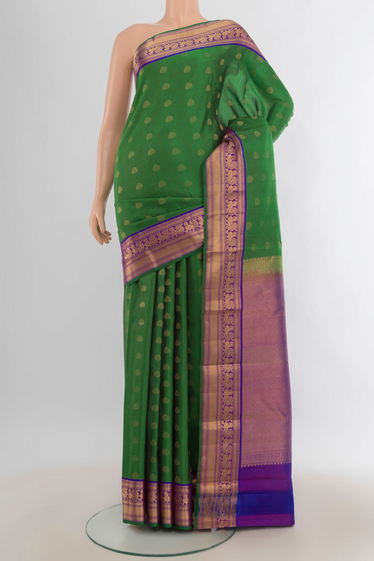 Pure Silk Mint Green Kanchipuram Saree with Zari Butta on the body and Silk Border.  displayed on a mannequin