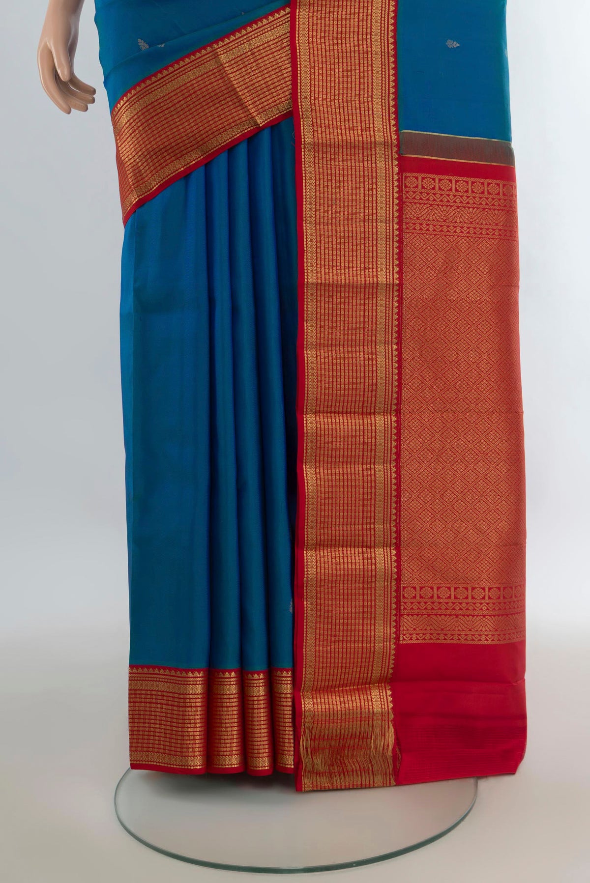 Pleats and pallu of Pure Silk Peacock Blue Kanchipuram Saree with Zari Butta on the body and Zari Border. 
