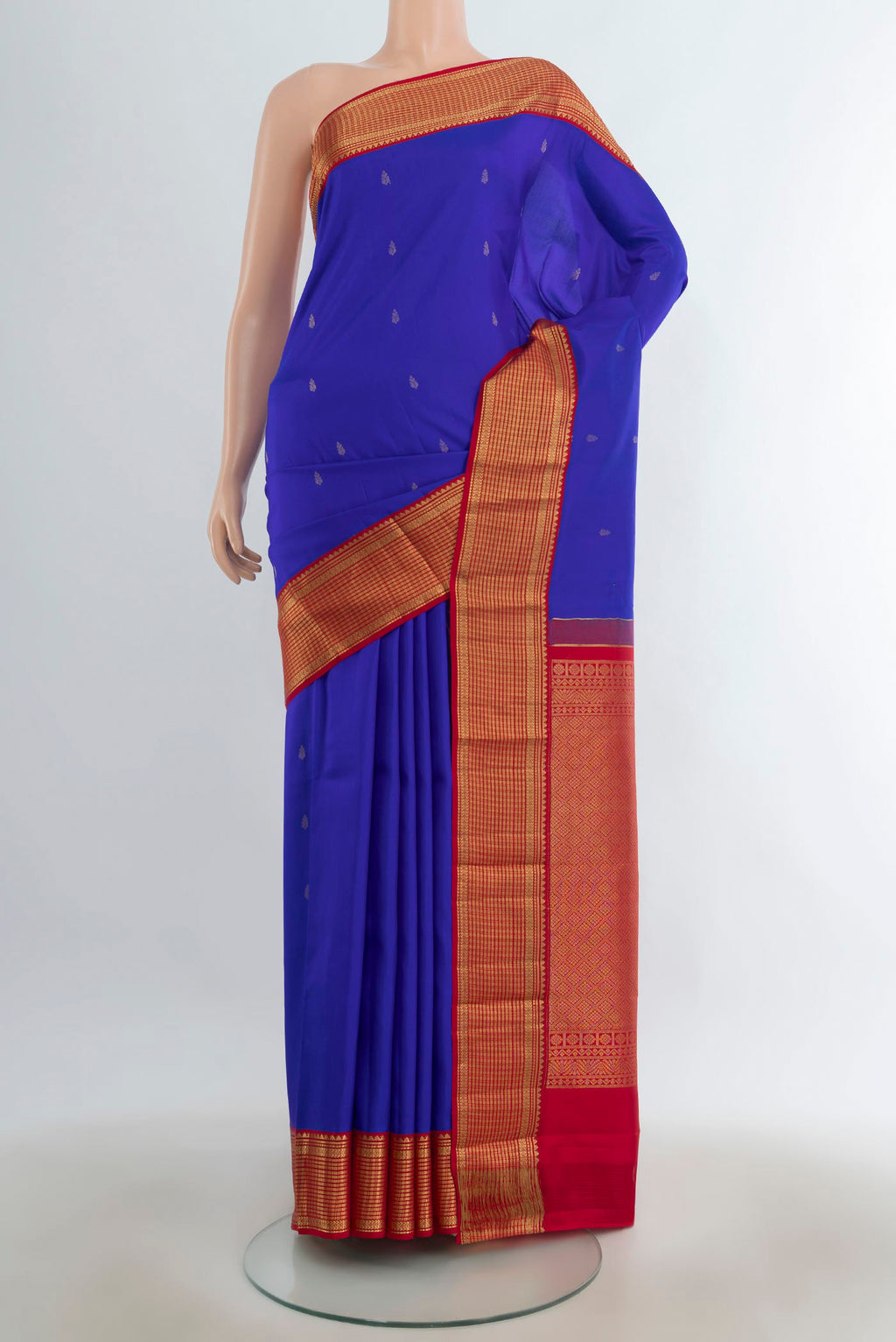 Pure Silk Dark Blue Kanchipuram Saree with Zari Butta on the body and Silk Border.  displayed on a mannequin