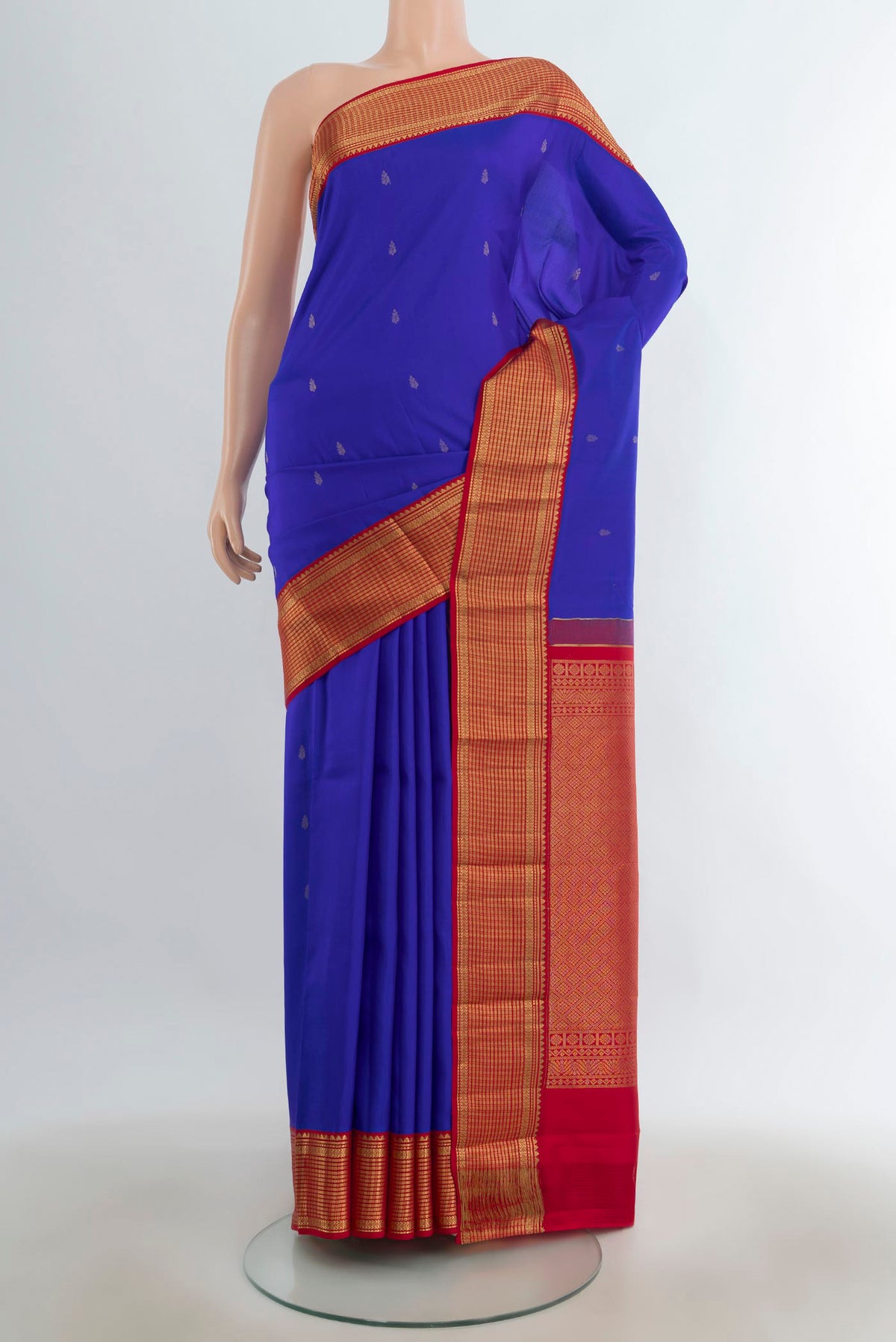 Pure Silk Dark Blue Kanchipuram Saree with Zari Butta on the body and Silk Border.  displayed on a mannequin