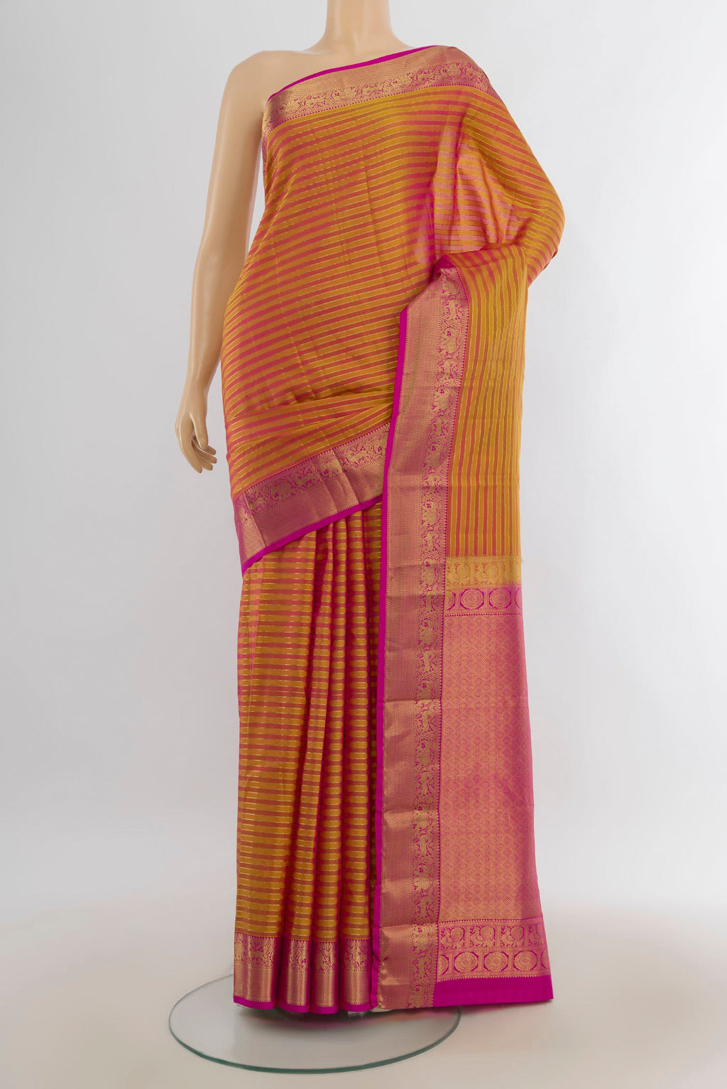 Pure Silk Golden Peach Kanjivaram Saree with Zari Butta on the body and Silk Border.  displayed on a mannequin