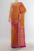 Pure Silk Golden Peach Kanjivaram Saree with Zari Butta on the body and Silk Border.  displayed on a mannequin