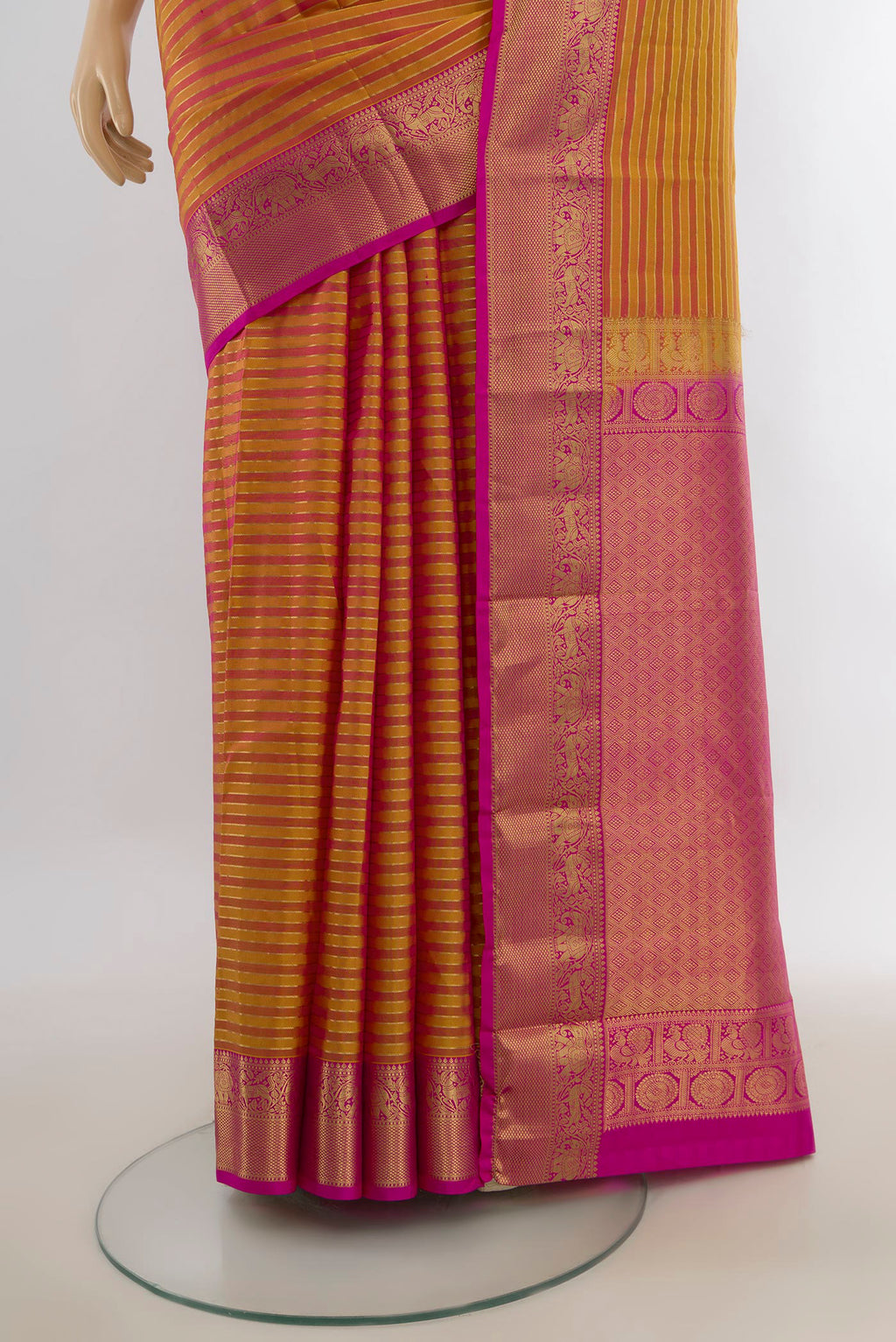 Pleats and pallu of Pure Silk Golden Peach Kanjivaram Saree with Zari Butta on the body and Silk Border. 