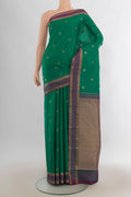 Pure Silk Green Kanchipuram Saree with Zari Butta on the body and Zari Border.  displayed on a mannequin