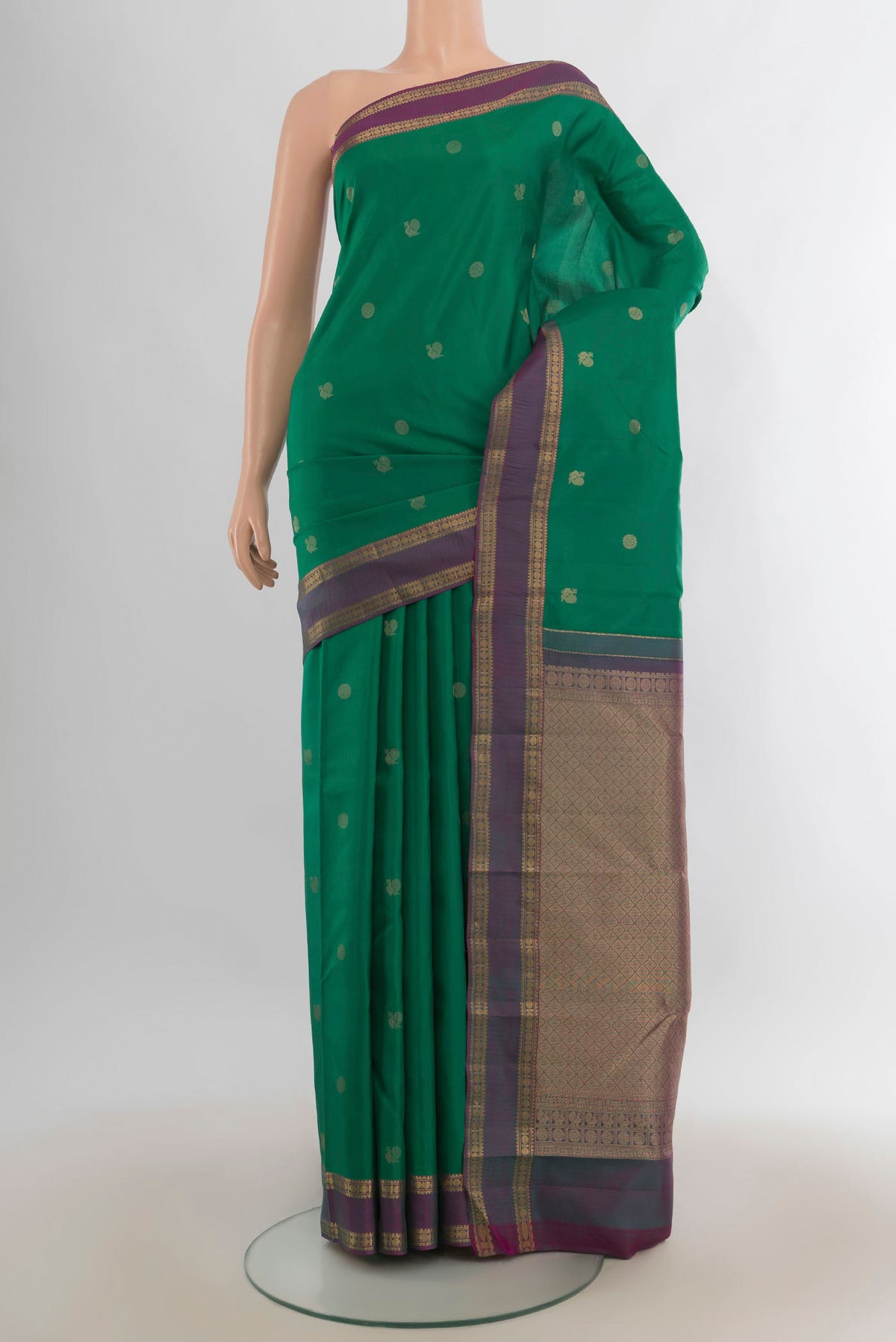 Pure Silk Green Kanchipuram Saree with Zari Butta on the body and Zari Border.  displayed on a mannequin