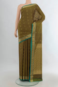 Pure Silk Mehandi Green Kanchipuram Saree with Zari Butta on the body and Zari Border.  displayed on a mannequin