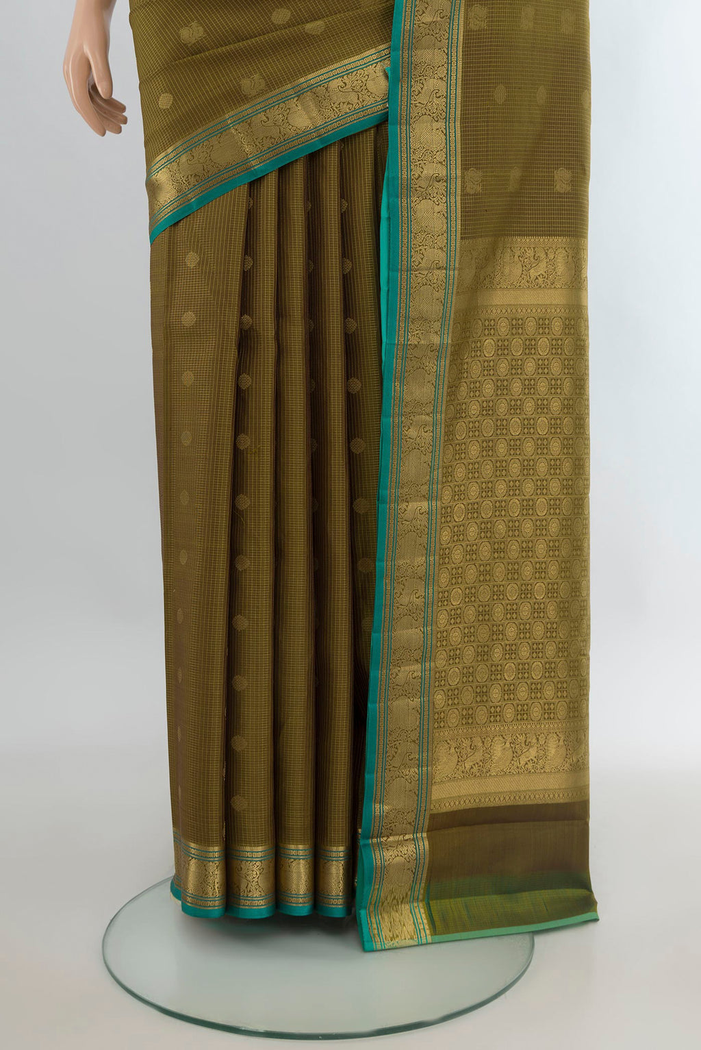Pleats and pallu of Pure Silk Mehandi Green Kanchipuram Saree with Zari Butta on the body and Zari Border. 