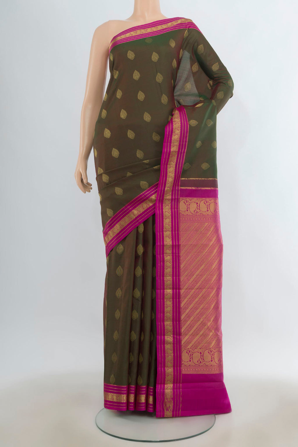 Pure Silk Mehandi Green Kanchipuram Saree with Zari Butta on the body and Zari Border.  displayed on a mannequin
