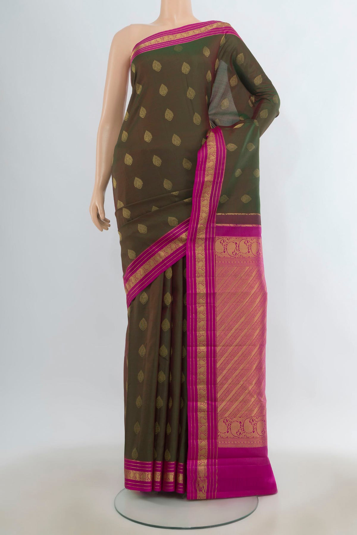 Pure Silk Mehandi Green Kanchipuram Saree with Zari Butta on the body and Zari Border.  displayed on a mannequin