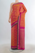 Pure Silk Peach Kanchipuram Saree with Zari Butta on the body and Silk Border.  displayed on a mannequin
