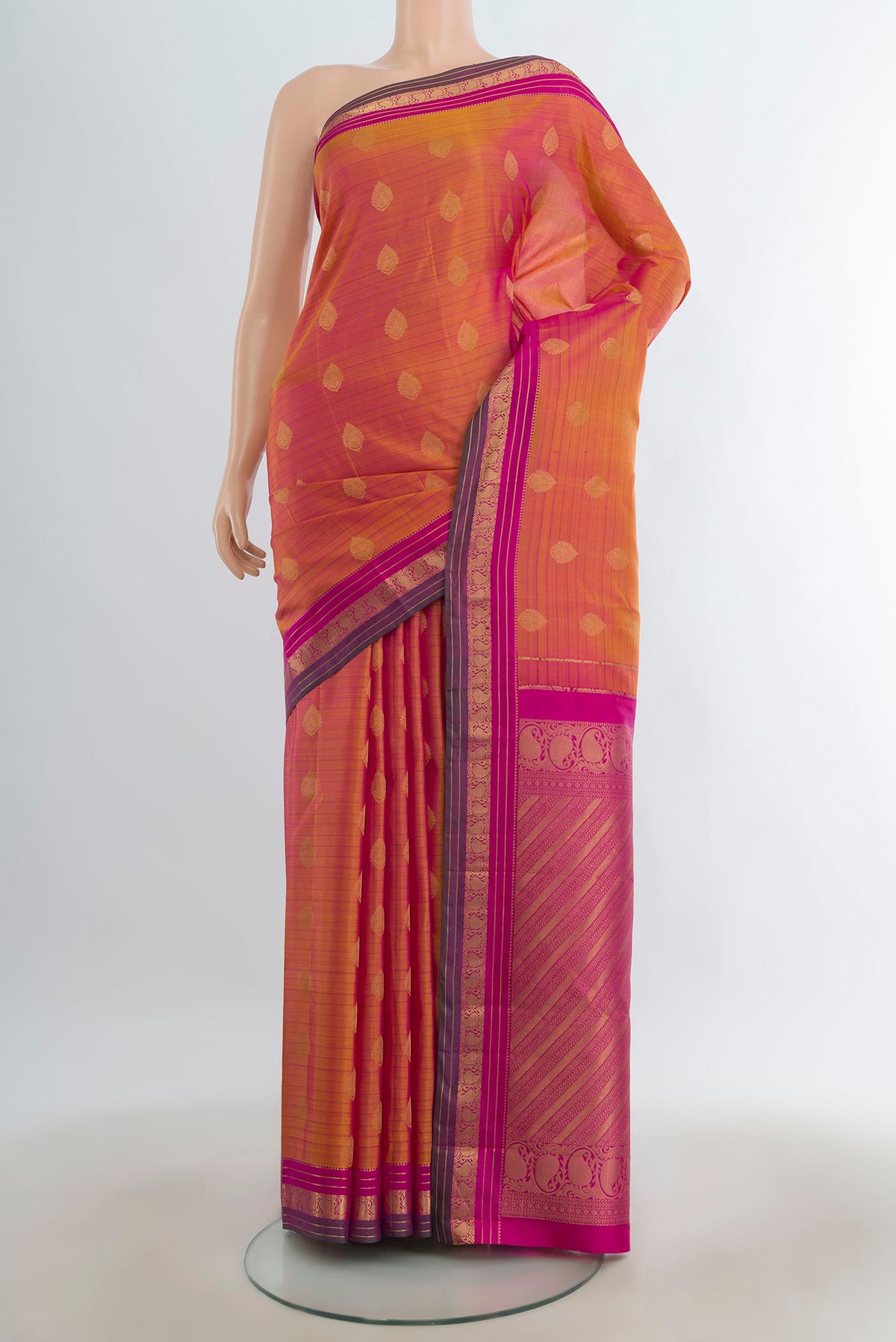 Pure Silk Peach Kanchipuram Saree with Zari Butta on the body and Silk Border.  displayed on a mannequin