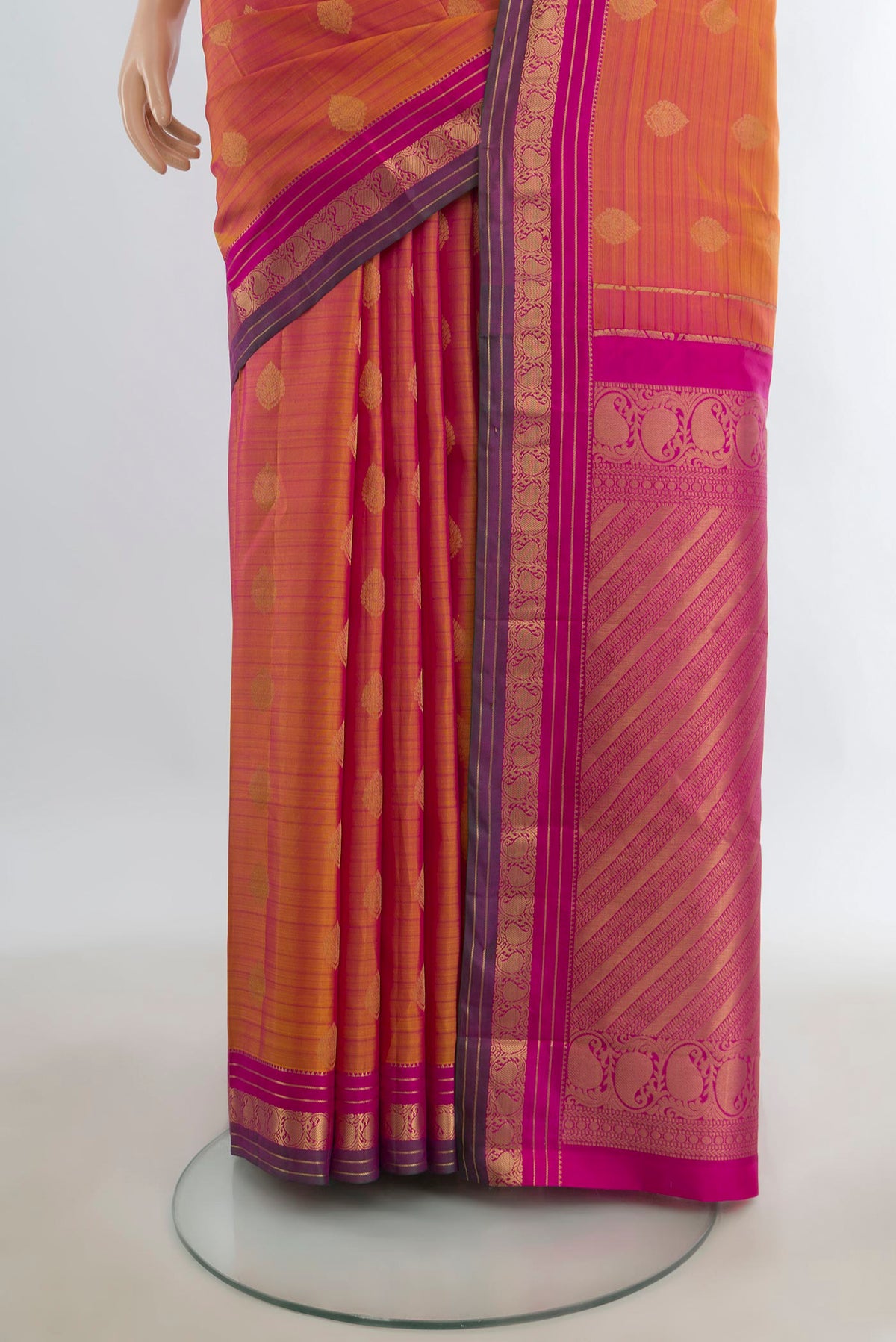 Pleats and pallu of Pure Silk Peach Kanchipuram Saree with Zari Butta on the body and Silk Border. 