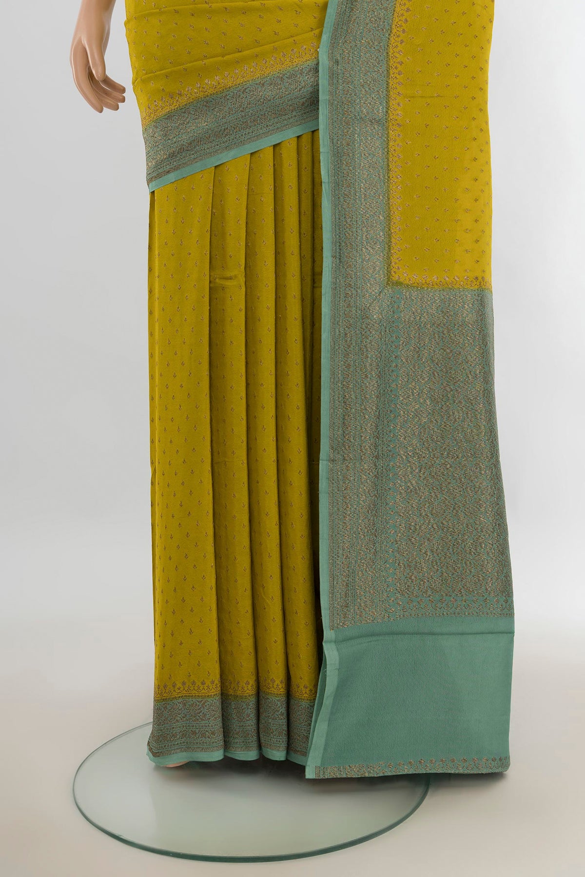 Pleats and pallu of Mehandi Green Banarasi Georgette Saree with Zari Butta on the body and Silk Border. 